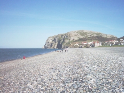 the pebbled beach with the great orme behind